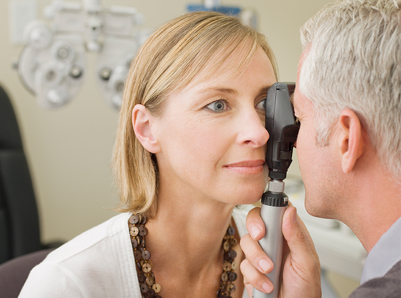 Woman having her eyes checked by Optometrist